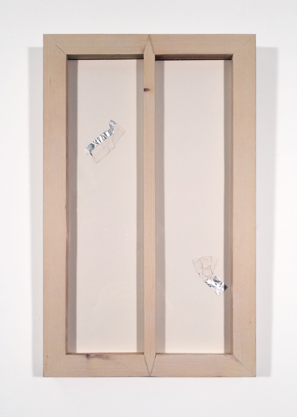 Silver leaf and marble paper cut to gum wrappers, crumbled, framed in oblong and tall frame with central divider.